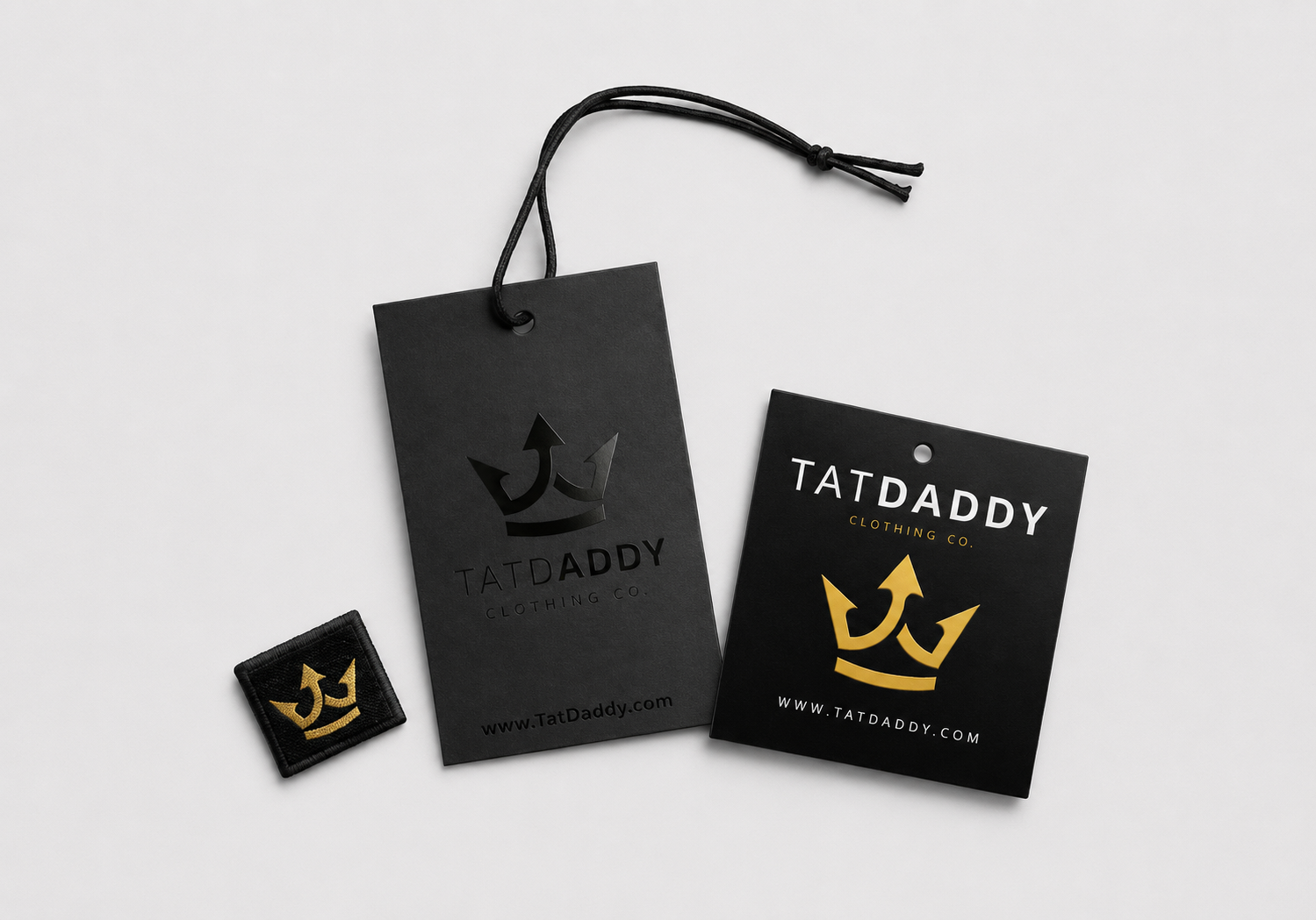 Custom black clothing hang tags and woven apparel label displayed on a light gray background as examples of branded hang tags for Boise apparel and merchandise.
