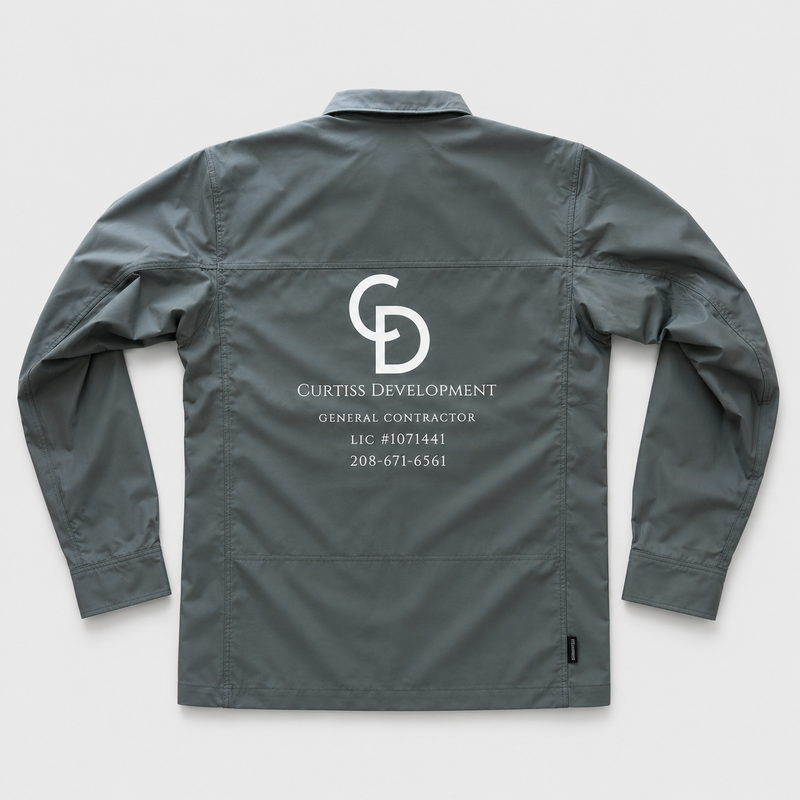 Gray work jacket with a custom printed Curtiss Development logo and contractor information on the back.