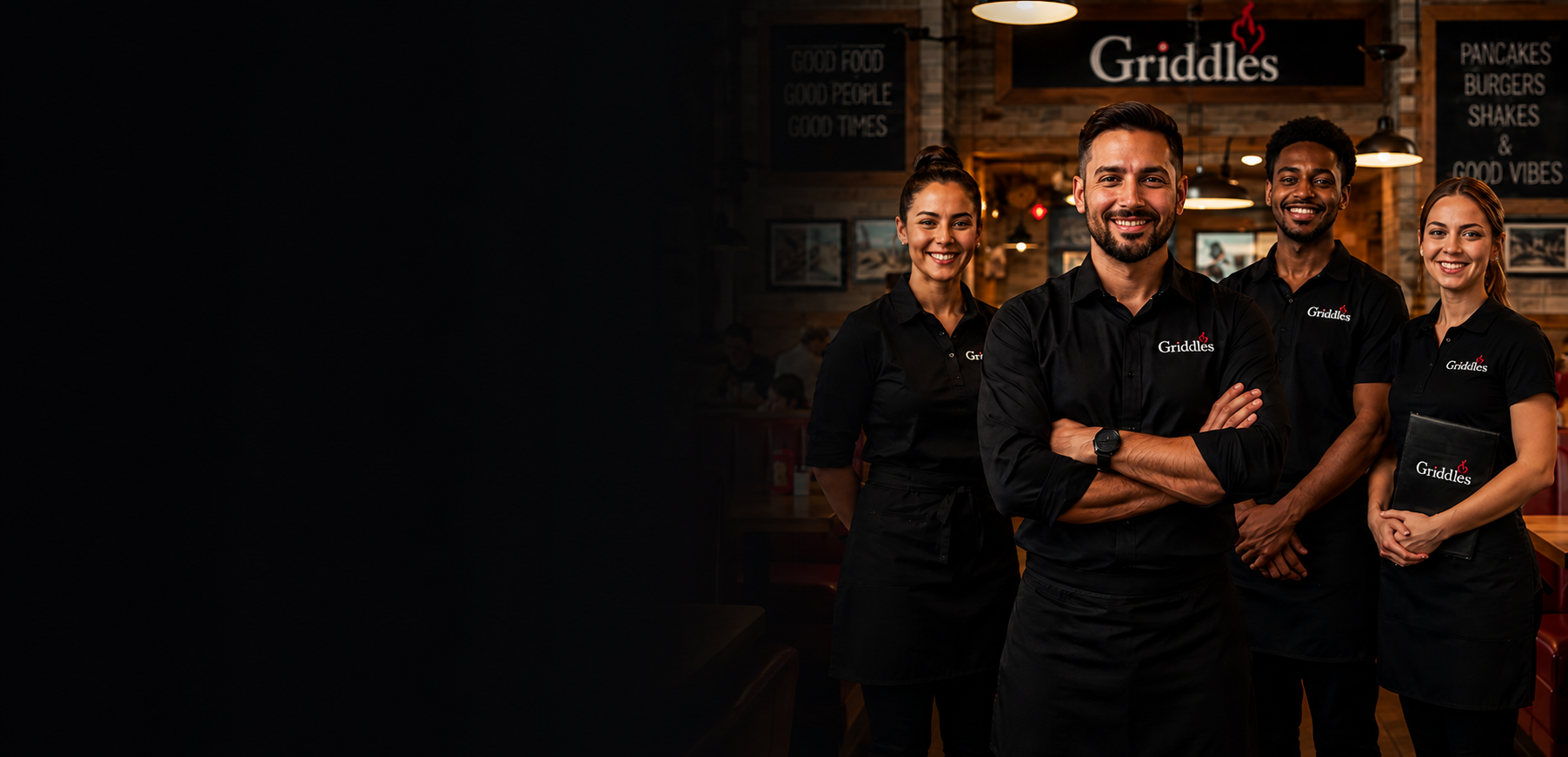 Restaurant team wearing custom black Griddles polos and aprons inside a diner.