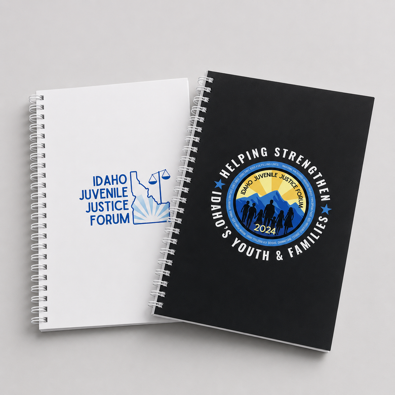 Two custom spiral notebooks with Idaho Juvenile Justice Forum and Idaho Juvenile Justice 2024 logos on white and black covers.